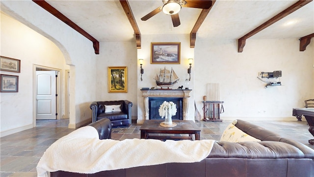 living room with ceiling fan and beam ceiling