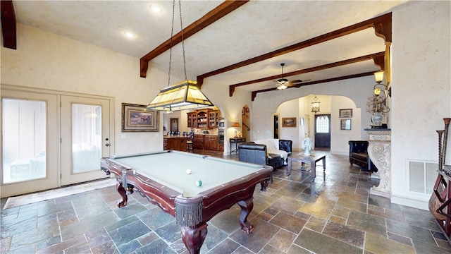 recreation room featuring pool table, a towering ceiling, beamed ceiling, and ceiling fan