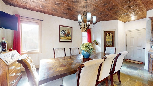 dining room with an inviting chandelier, vaulted ceiling, and a healthy amount of sunlight