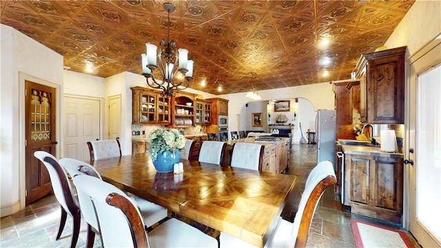 dining area with a notable chandelier and sink