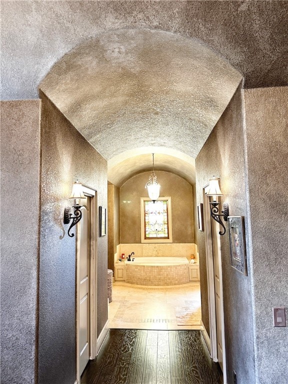 interior space featuring hardwood / wood-style floors and vaulted ceiling