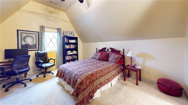 bedroom with vaulted ceiling, ceiling fan, and carpet floors