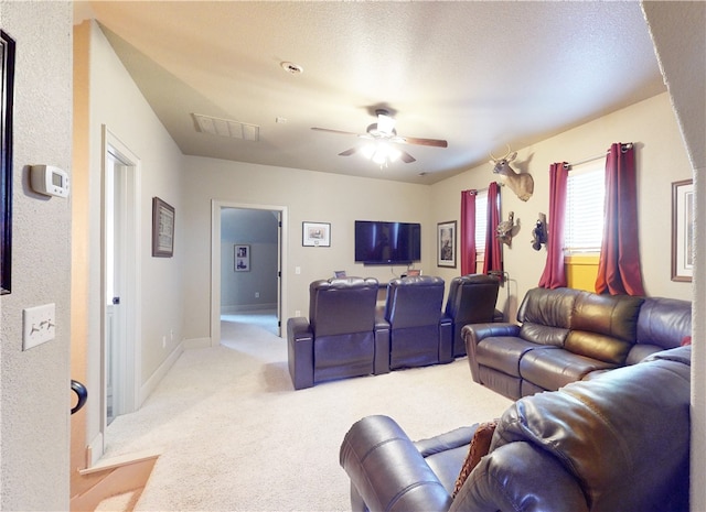 carpeted living room featuring ceiling fan