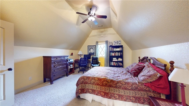 carpeted bedroom with vaulted ceiling, ceiling fan, and a textured ceiling