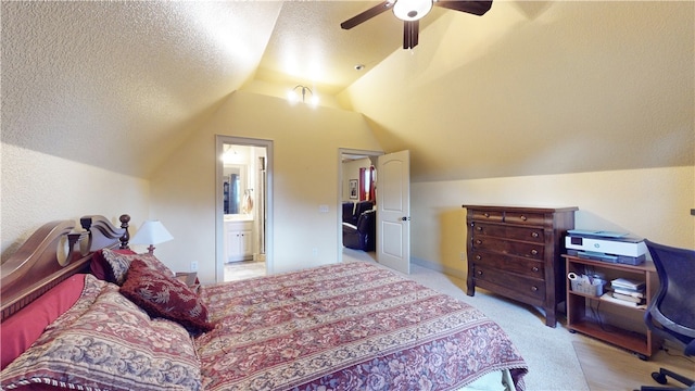 carpeted bedroom featuring connected bathroom, lofted ceiling, a textured ceiling, and ceiling fan