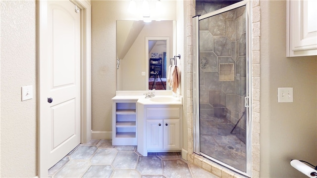 bathroom with walk in shower and vanity