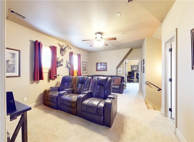 carpeted cinema room featuring ceiling fan, a textured ceiling, and lofted ceiling