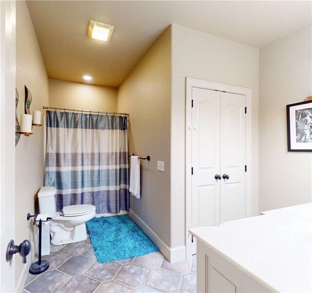 bathroom featuring walk in shower, tile patterned flooring, and toilet