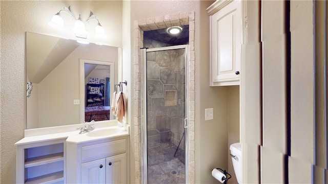 bathroom with a shower with door, vanity, and toilet