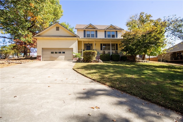 view of front of house featuring covered porch, a front yard, and a garage