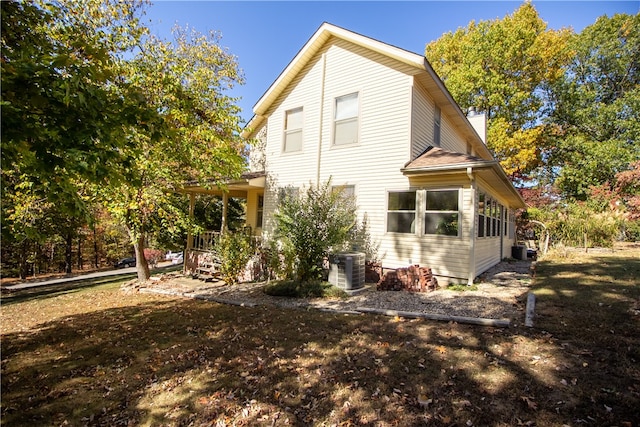 view of side of home with covered porch and central air condition unit