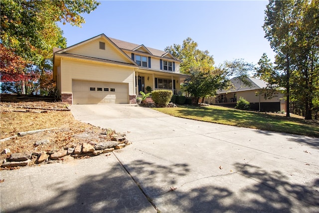 view of front of house with a garage, a front lawn, and a porch