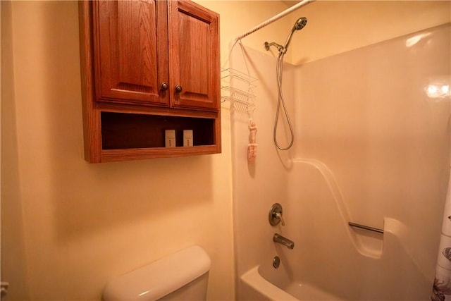 bathroom featuring toilet and shower / bathing tub combination