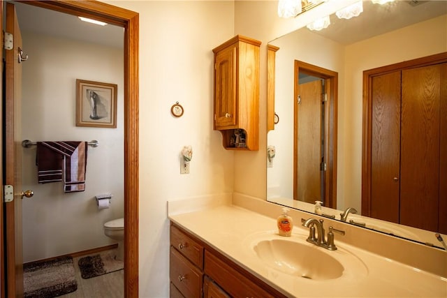 bathroom featuring vanity and toilet