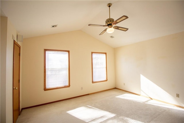 spare room featuring light carpet, ceiling fan, and lofted ceiling