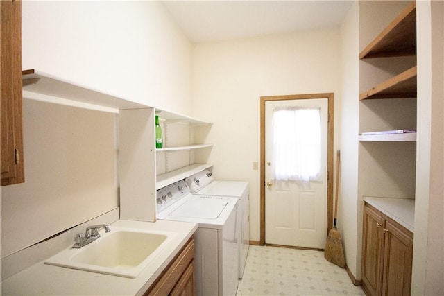 laundry room featuring cabinets, sink, and washing machine and clothes dryer