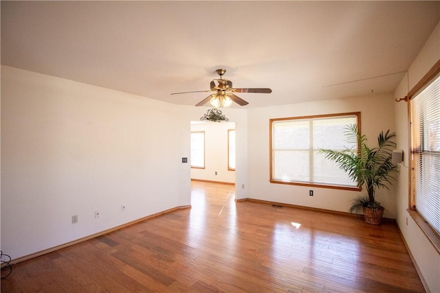 empty room featuring light wood-type flooring and ceiling fan