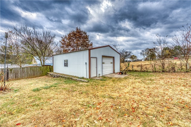 view of outdoor structure with a garage and a yard