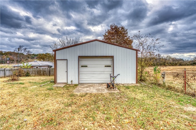 view of outbuilding featuring a garage and a yard