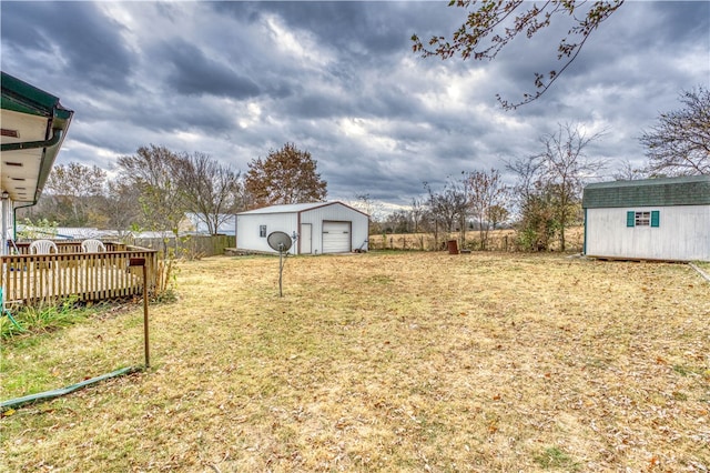 view of yard featuring a garage and a storage shed