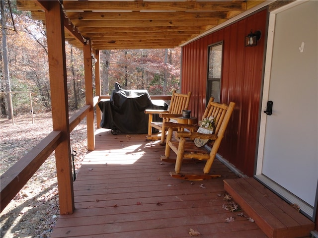 wooden deck with a grill