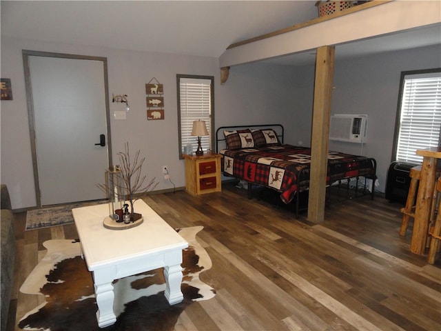 bedroom featuring dark wood-type flooring, a wall mounted AC, and lofted ceiling