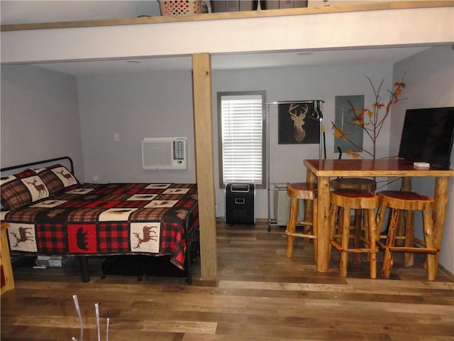 305 Deer Run Rd, Leslie, AR 72645 - bedroom featuring wood finished floors, a wall unit AC, and a bar