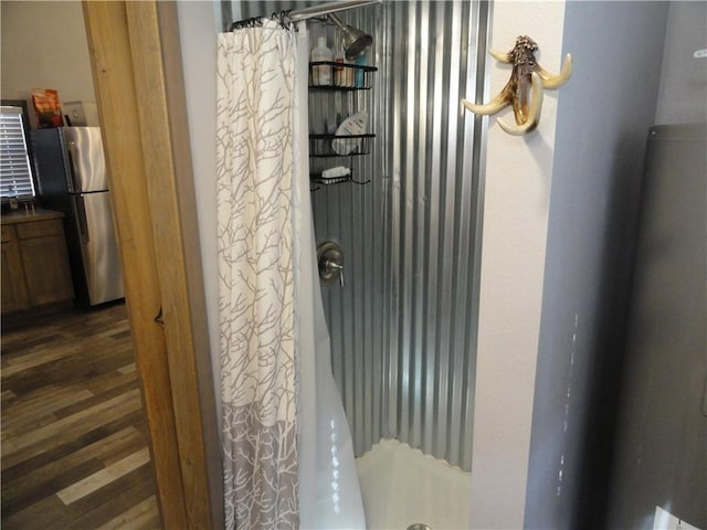 305 Deer Run Rd, Leslie, AR 72645 - detailed view of freestanding refrigerator and wood finished floors