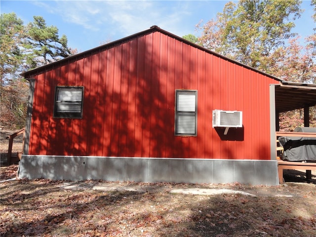 view of property exterior with a wall unit AC