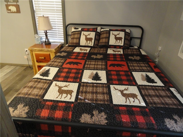 bedroom with hardwood / wood-style flooring