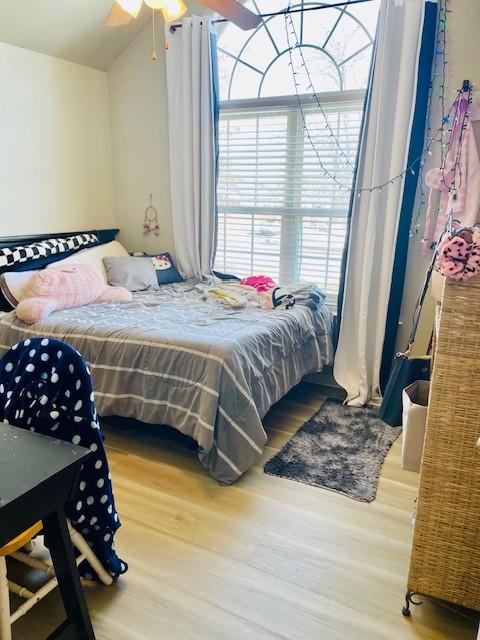 bedroom with hardwood / wood-style floors and ceiling fan