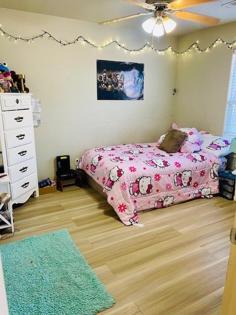 bedroom with hardwood / wood-style floors and ceiling fan