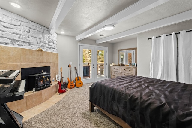 tiled bedroom with access to exterior, beam ceiling, a textured ceiling, and french doors