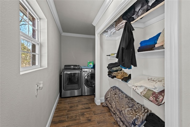 laundry area with washing machine and clothes dryer, dark hardwood / wood-style floors, and crown molding