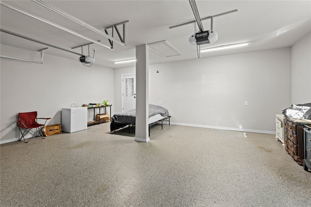 garage with a garage door opener and white refrigerator