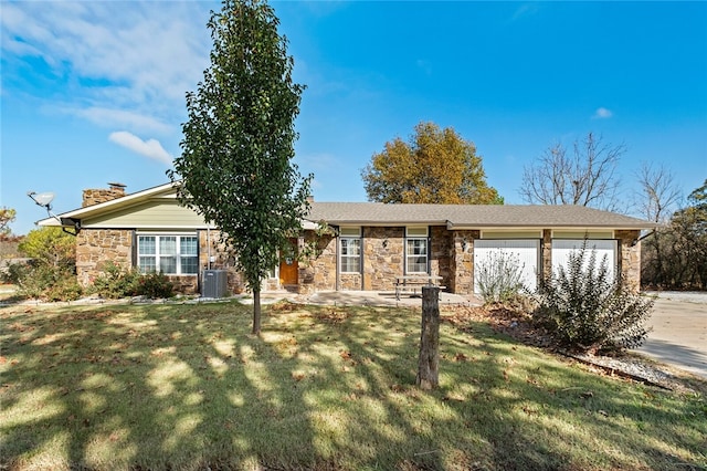 ranch-style house featuring a garage, a front lawn, and central AC