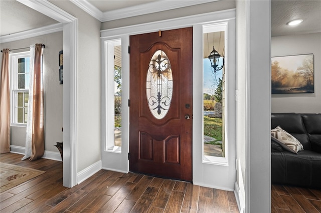 foyer entrance with dark wood-type flooring, a textured ceiling, a healthy amount of sunlight, and crown molding