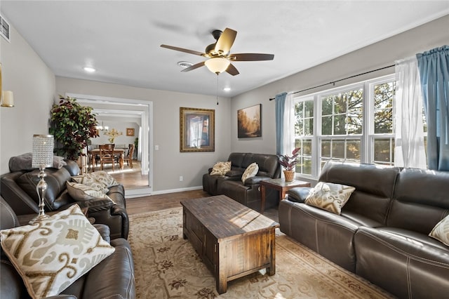 living room with light hardwood / wood-style floors and ceiling fan