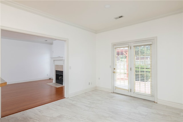 unfurnished living room featuring a fireplace, light hardwood / wood-style floors, and crown molding