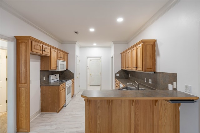 kitchen with kitchen peninsula, sink, white appliances, and backsplash