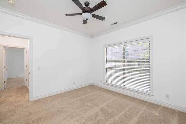 unfurnished room with ceiling fan, light carpet, and crown molding