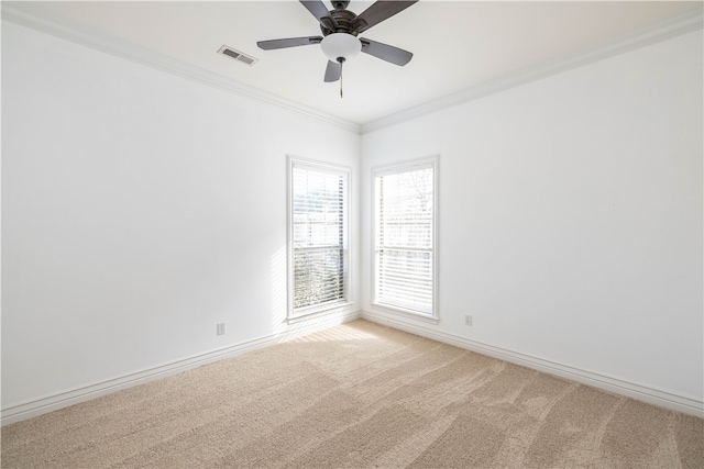 carpeted empty room with ceiling fan and ornamental molding