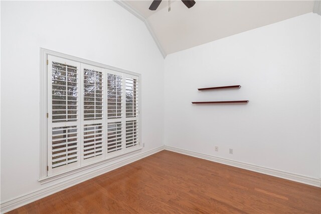 spare room featuring wood-type flooring, ceiling fan, and lofted ceiling