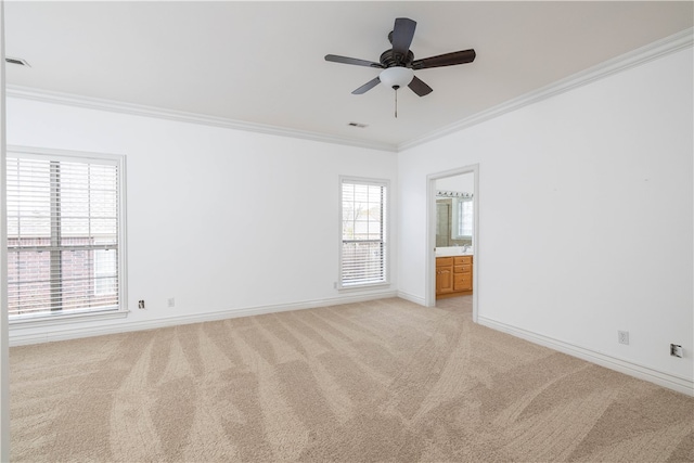 carpeted empty room featuring ceiling fan and crown molding