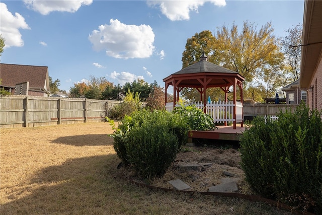 view of yard with a deck and a gazebo