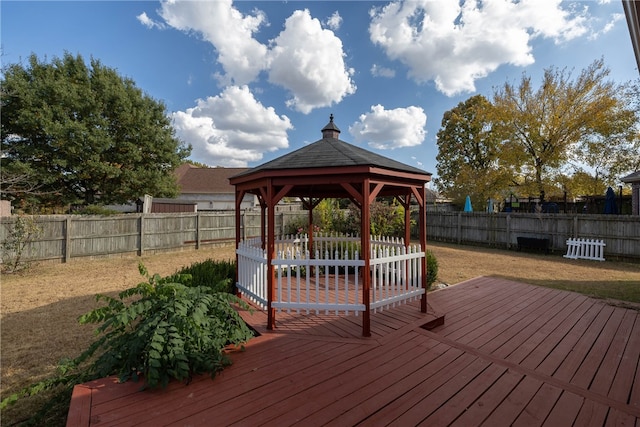 wooden terrace featuring a yard and a gazebo