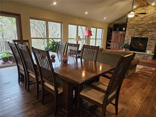 dining room featuring lofted ceiling with beams, dark hardwood / wood-style flooring, ceiling fan, and a healthy amount of sunlight