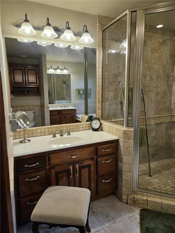 bathroom with vanity, tile patterned floors, and an enclosed shower