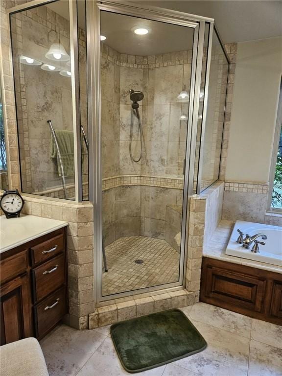 bathroom with tile patterned flooring, vanity, tile walls, and plus walk in shower