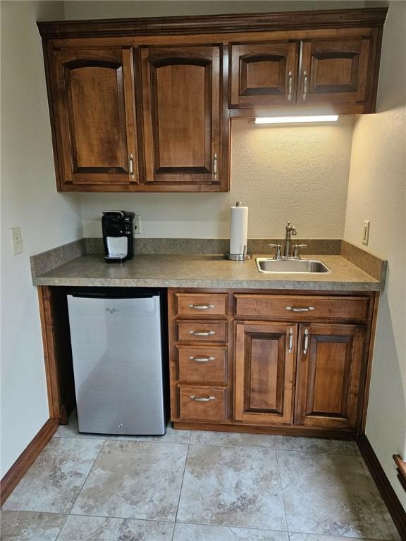 kitchen with stainless steel fridge and sink